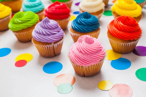 Gran cantidad de magdalenas de cumpleaños con crema de mantequilla de colores —  Fotos de Stock