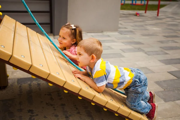 Kids climbing the rope on modern playground — 스톡 사진