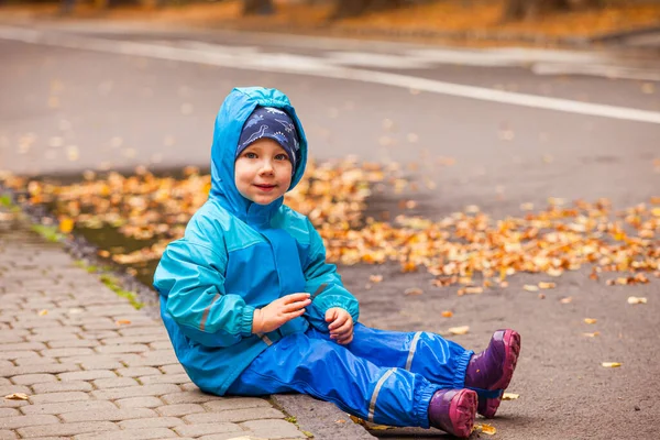 秋の雨の日を歩くかわいい男の子 — ストック写真