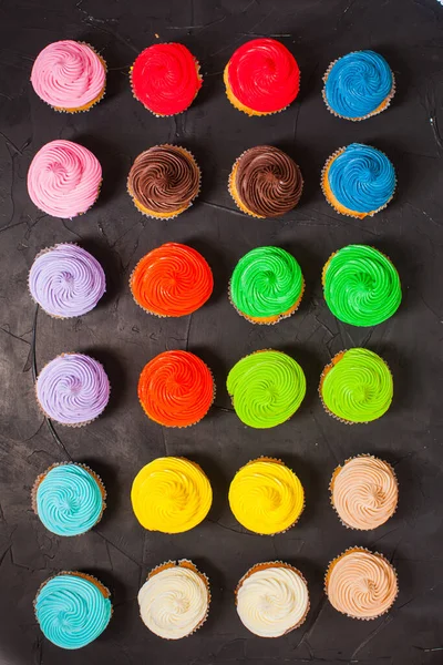 The lot of delicious multi-colored cupcakes closeup — Stock Photo, Image