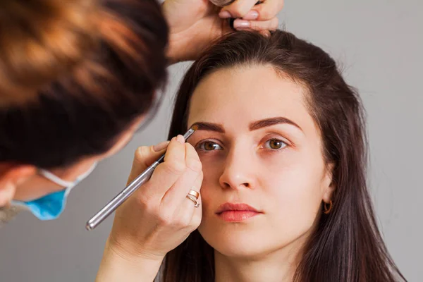 Young woman having professional eyebrow correction procedure — 스톡 사진