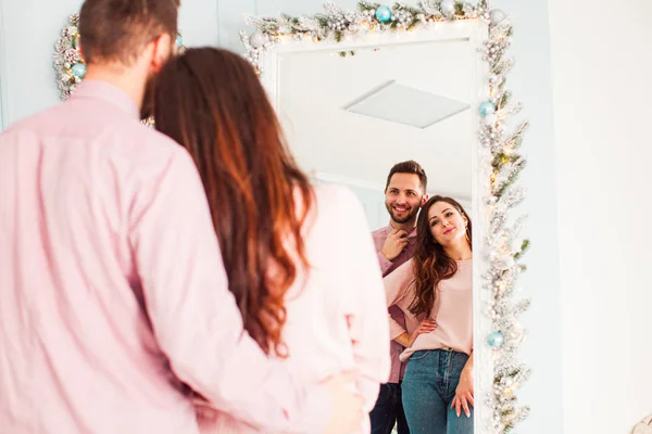 Ρομαντικό ζευγάρι δούμε σχεδιασμένο καθρέφτη με χριστουγεννιάτικη διακόσμηση — Φωτογραφία Αρχείου