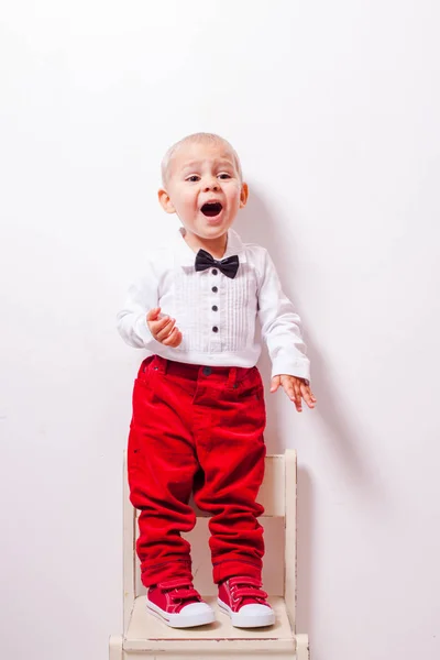 Little boy stands at the chair and tells a poem — Stock Photo, Image