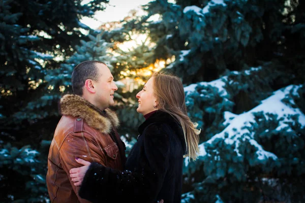 Casal feliz no amor abraçar na floresta fria inverno nevado — Fotografia de Stock