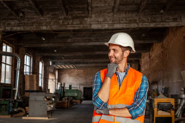 Portrait of young worker indoors old woodworking plant