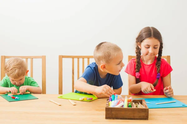 Niedliche kleine Kinder modellieren aus Spielteig zu Hause — Stockfoto