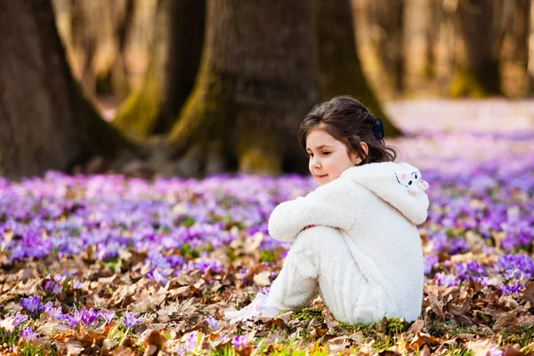 Little girl in white warm romper outdoors in spring forest — Stock Photo, Image