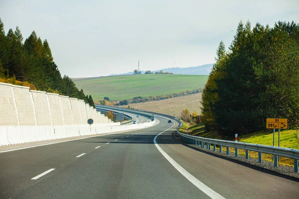 Cars driving on the asphalt road passing through the mountain — Stock Photo, Image