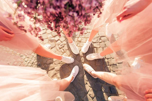 Happy girlfriends making circle with legs top view — Stock Photo, Image