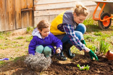 Mother and daughter working in their garden