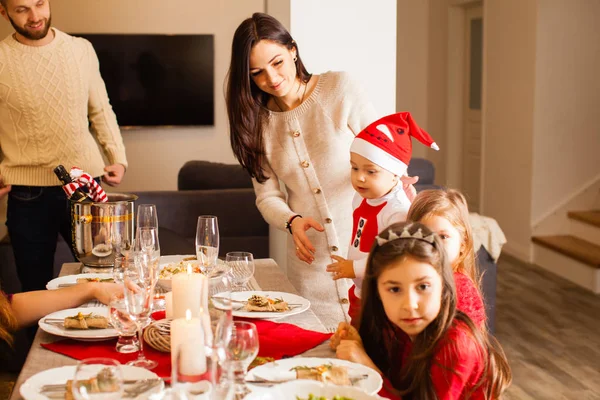 Children sitting at the table on New Years eve party — ストック写真