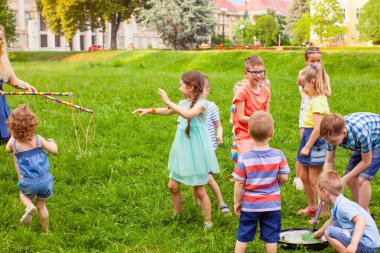 Group of kids having fun together at summer park