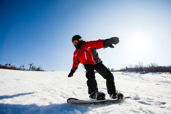 Young freerider on snowboarboard in action on slope — 图库照片