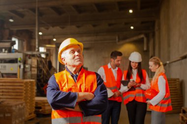 Happy man in protective hard hat at his working place