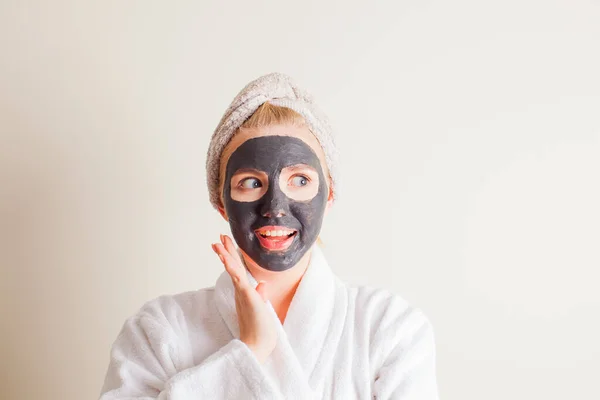 Young beautiful woman in a mask for the face of the therapeutic black mud — 스톡 사진