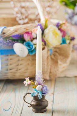 White candle decorated with flowers. Easter concept