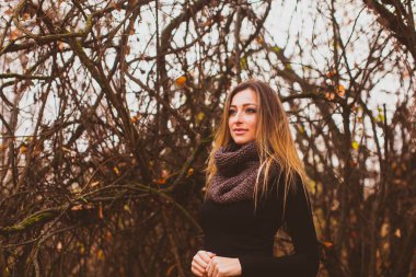 Beautiful romantic woman on a walk in autumn. Woman with healthy long hair.