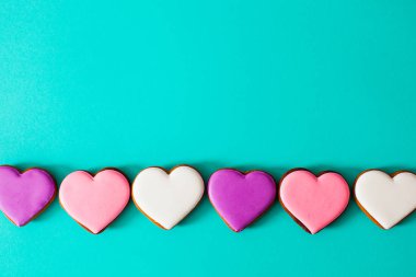 Row of pink and white glazed cookies