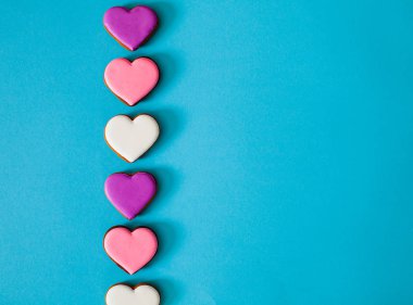 Top view colorful hearts on blue background