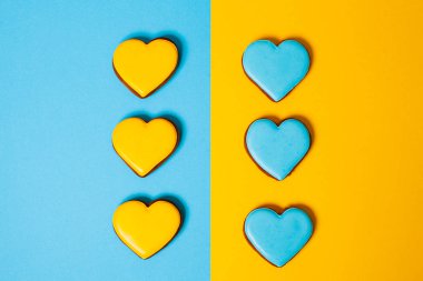 Heart shaped cookies on color background, flat lay