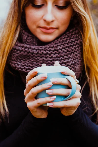 Girl enjoying hot tea outdoors in autumn day. Womens hands with perfect manicure. Autumn mood and lifestyle. — Stock Photo, Image