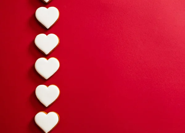 Five white hearts on red paper sheet — Stockfoto
