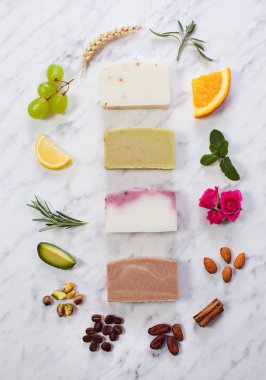 Slices of homemade soap in circle of natural ingredients