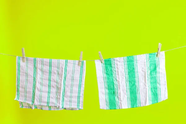 Kitchen towels with clothespins hanging on clothesline — Stock Photo, Image
