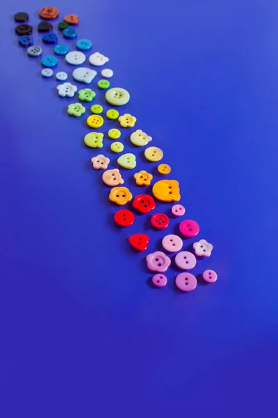 Path made of multicolor buttons on blue background — 图库照片