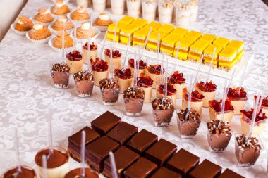 Delicious sweet table with different luxury desserts and cakes for a party