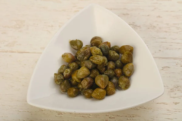 Marinated capers in the bowl — Stock Photo, Image