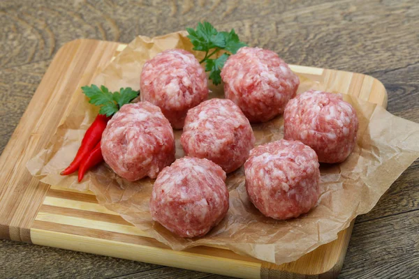 Raw meatballs with pepper — Stock Photo, Image