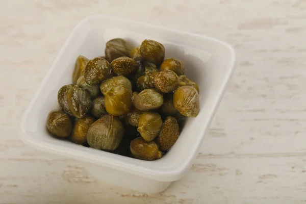 Pickled capers in the bowl — Stock Photo, Image