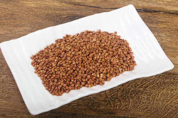 Raw buckwheat in the bowl — Stock Photo, Image