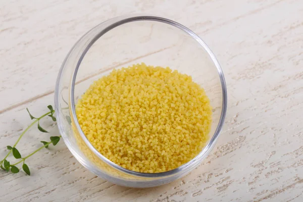 Raw couscous in the bowl — Stock Photo, Image