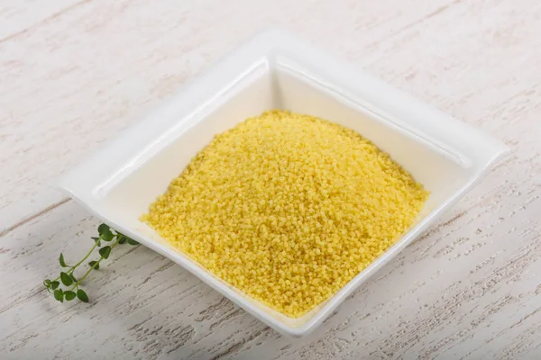 Raw couscous  in the bowl — Stock Photo, Image