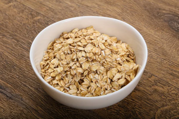 Raw oatmeal in the bowl — Stock Photo, Image
