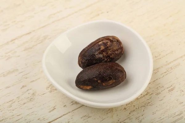 Two Nutmegs in the bowl — Stock Photo, Image