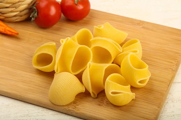 Raw pasta on chopping board