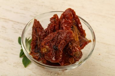 Kurutulmuş domates zeytin yağı fesleğen yaprakları ile