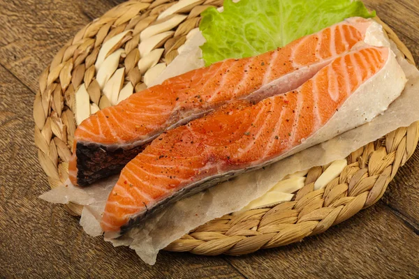 Raw salmon slices ready for baking with spices