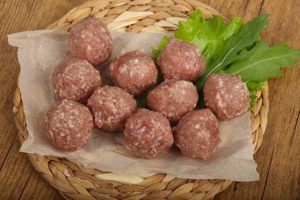 Raw meat balls on paper — Stock Photo, Image