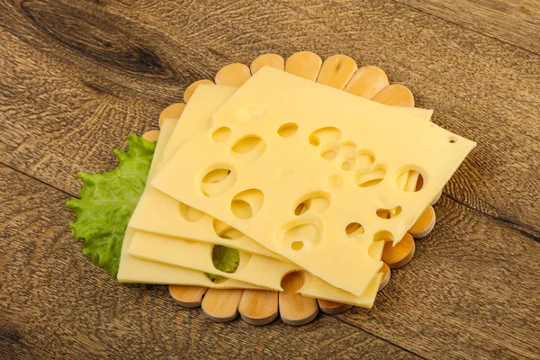 Sliced cheese with salad leaf — Stock Photo, Image