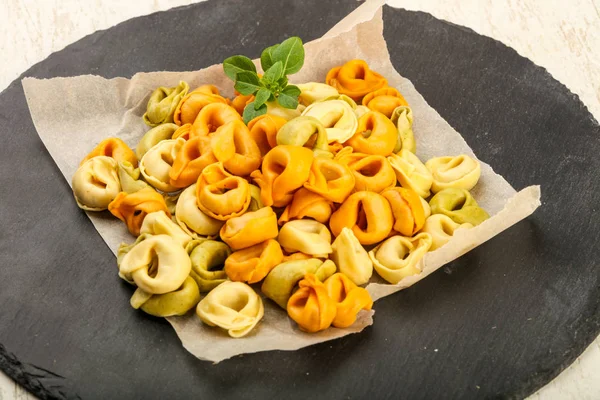 Raw tortellini with basil — Stock Photo, Image