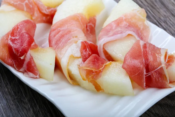 Melon with prosciutto appetizer — Stock Photo, Image