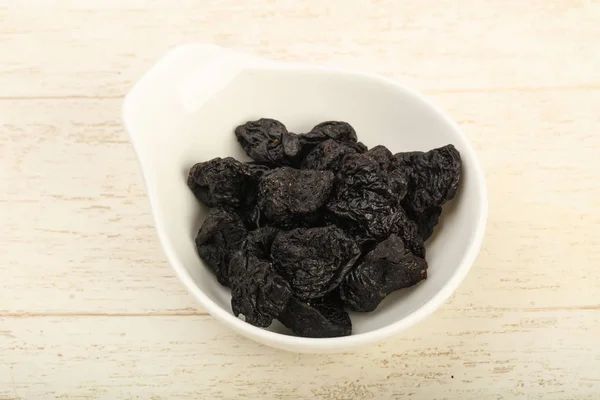 Dried plums in the bowl