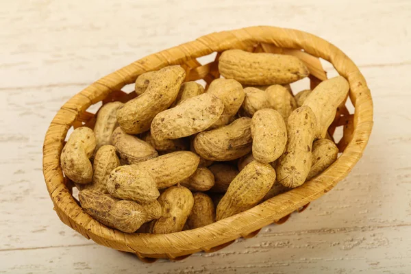 Unpeeled peanuts in the basket — Stock Photo, Image