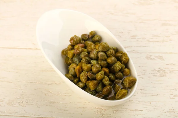 Pickled capers in the bowl — Stock Photo, Image