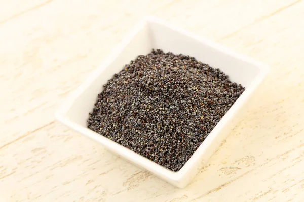 Poppy seeds in the bowl — Stock Photo, Image