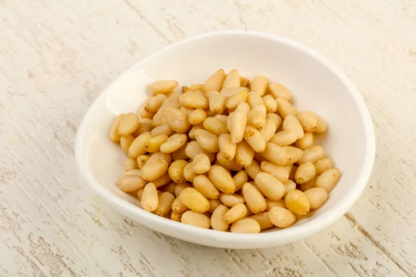 Cedar nuts in the bowl — Stock Photo, Image